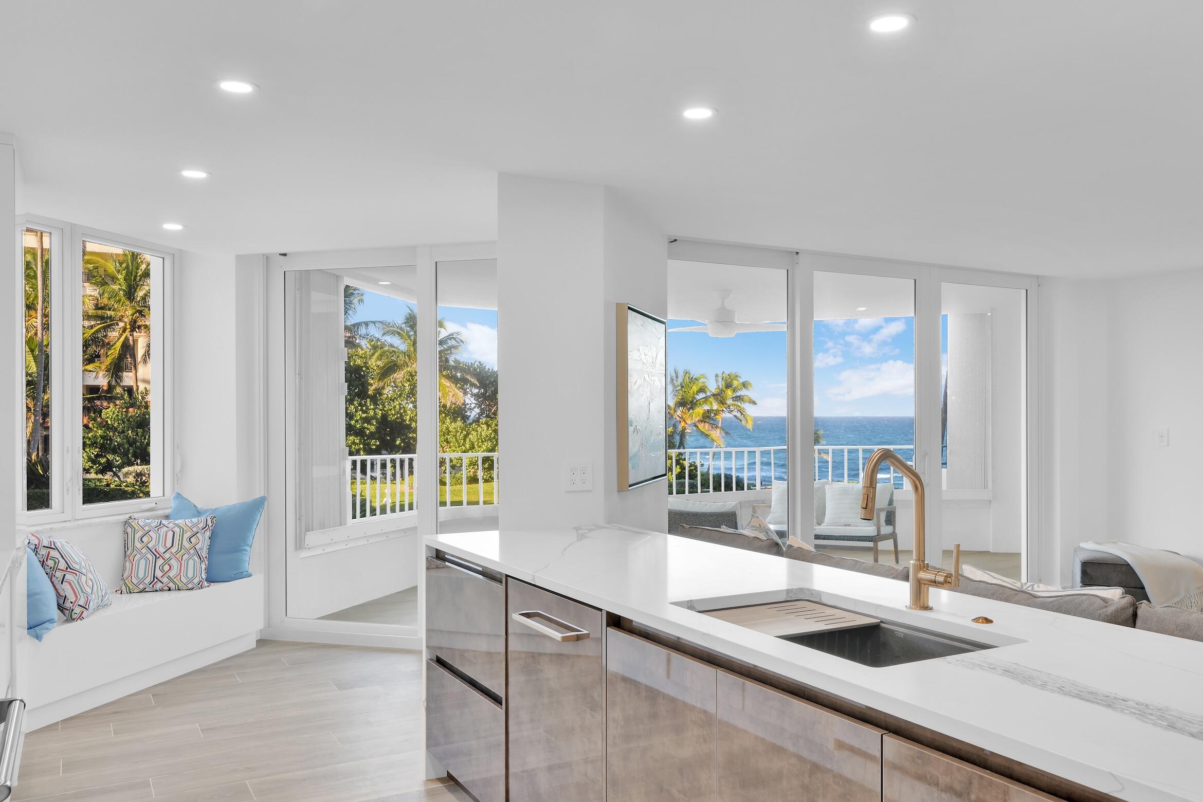 500 South Ocean Boulevard, Unit 303 Boca Raton, FL 33432 - Photo 4 of 46 a kitchen with large windows and a sink