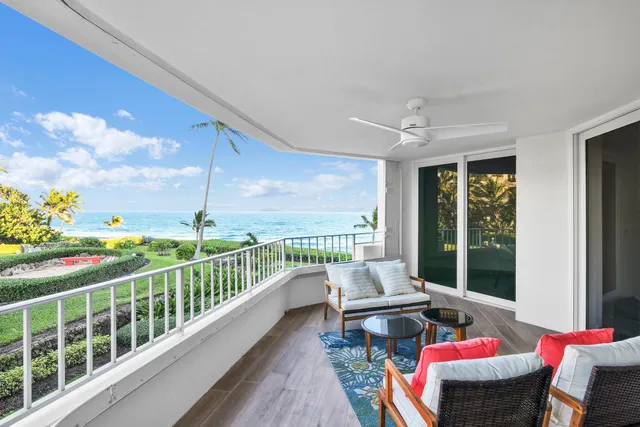 a balcony with furniture and wooden floor
