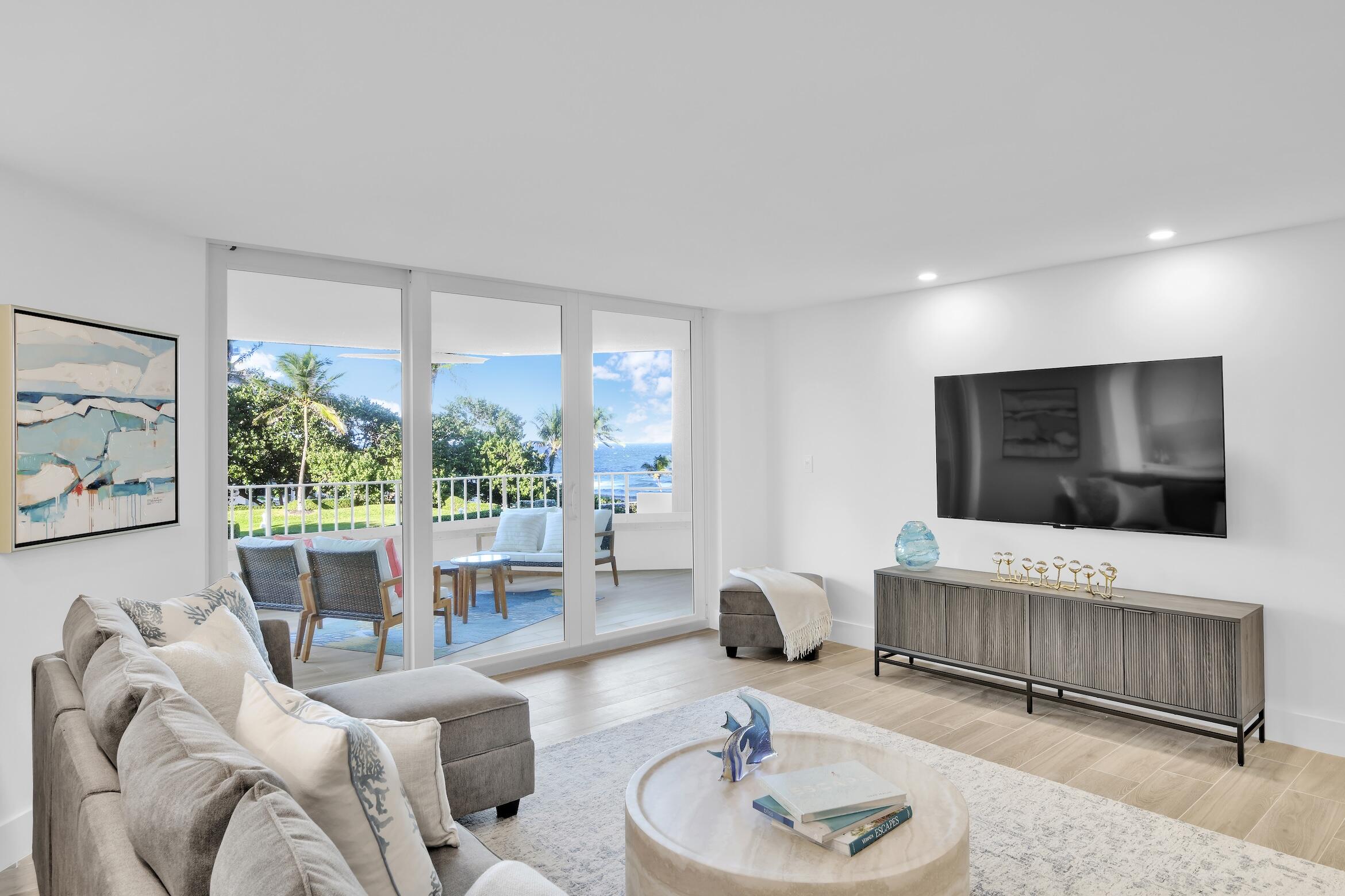 500 South Ocean Boulevard, Unit 303 Boca Raton, FL 33432 - Photo 6 of 46 a living room with furniture and a flat screen tv