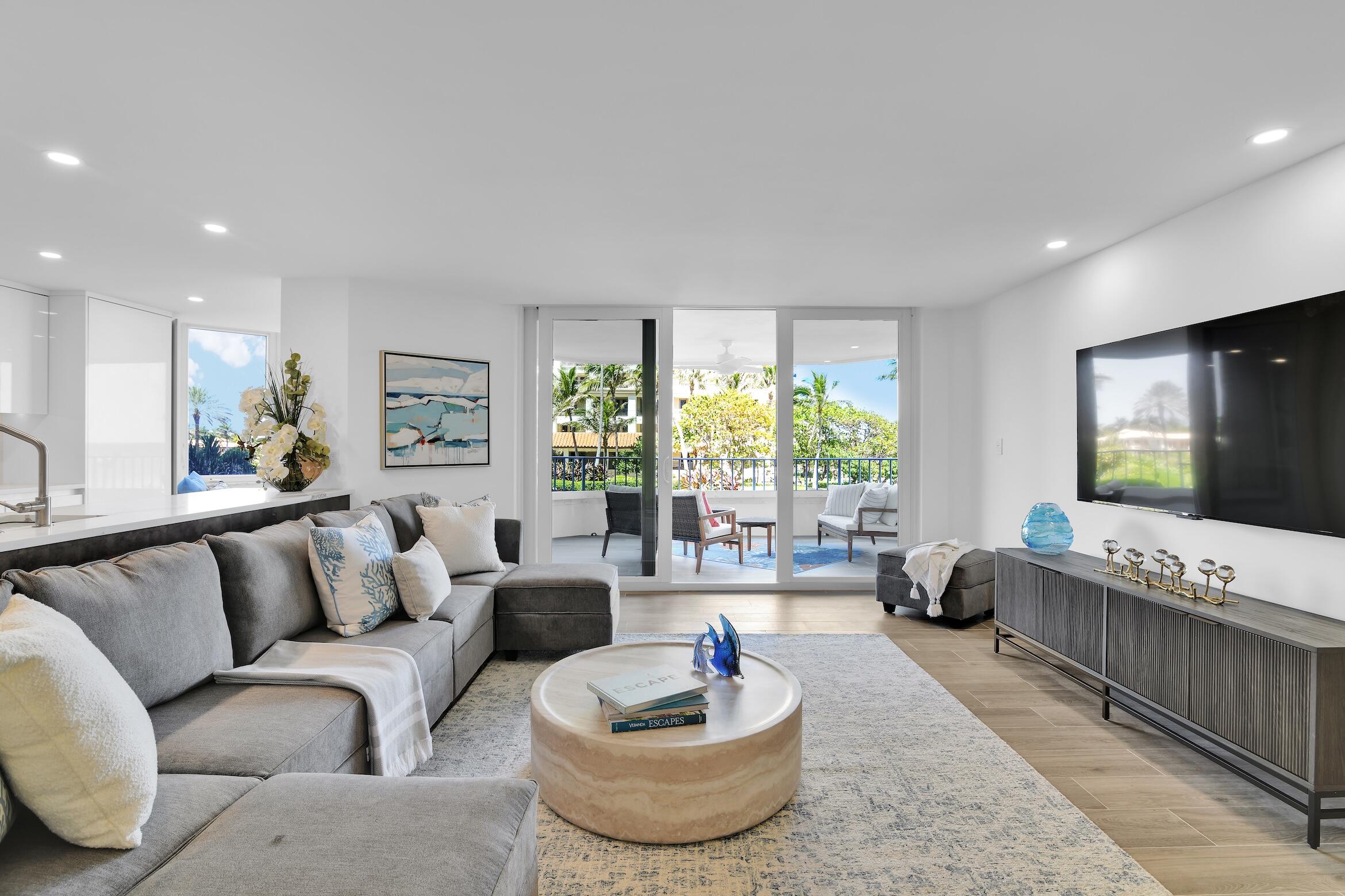 500 South Ocean Boulevard, Unit 303 Boca Raton, FL 33432 - Photo 7 of 46 a living room with furniture and a flat screen tv