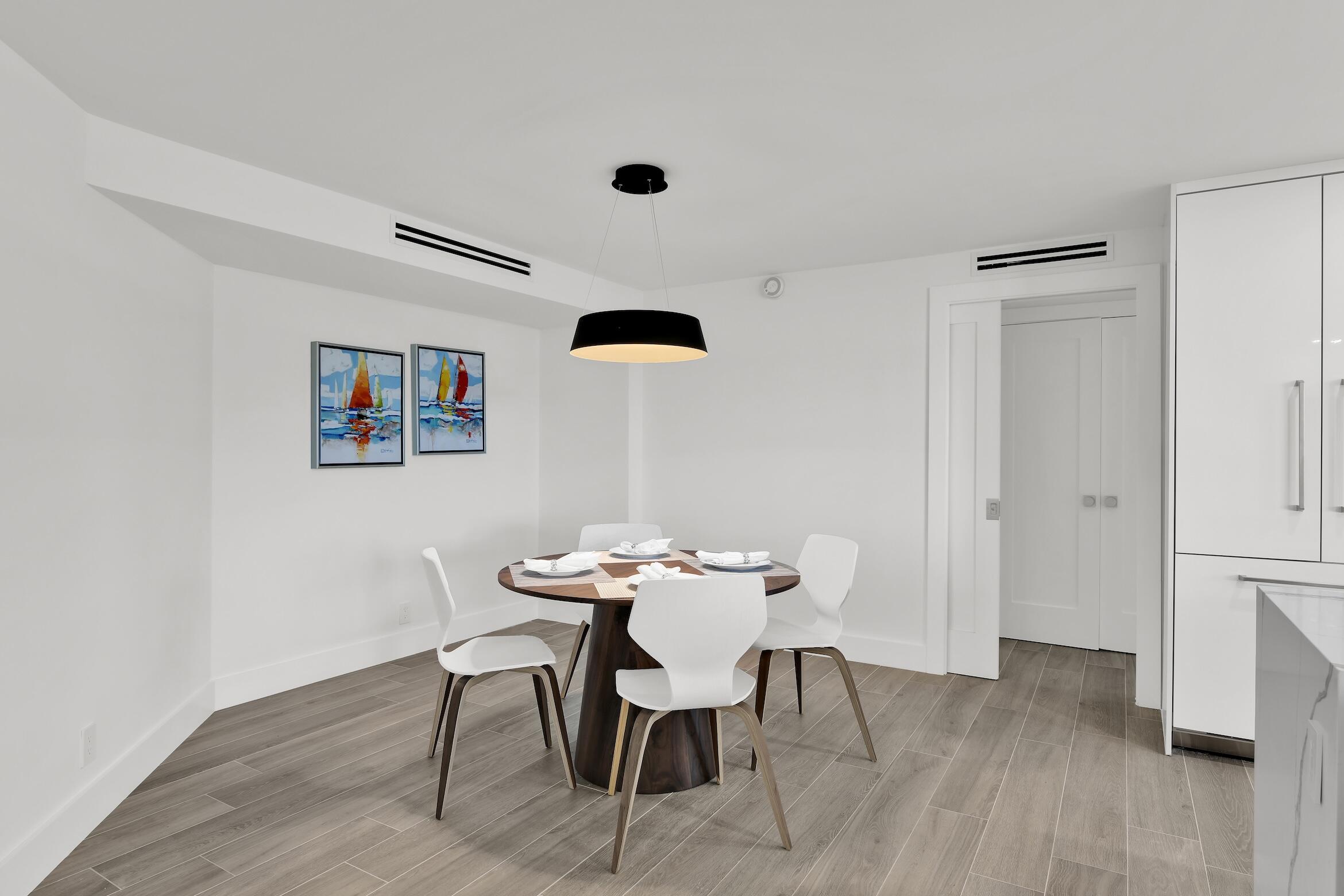 500 South Ocean Boulevard, Unit 303 Boca Raton, FL 33432 - Photo 10 of 46 a view of a dining room with furniture and wooden floor