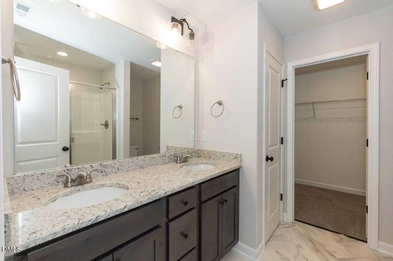 1020 Raven Street Durham, NC 27704 - Photo 11 of 13 a bathroom with a granite countertop sink and mirror