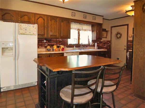 212 Gage Road Athol, MA 01331 - Photo 5 of 9 a kitchen with stainless steel appliances granite countertop a table chairs and a refrigerator