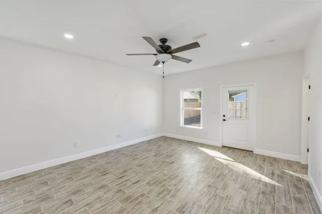 a view of an empty room with a kitchen
