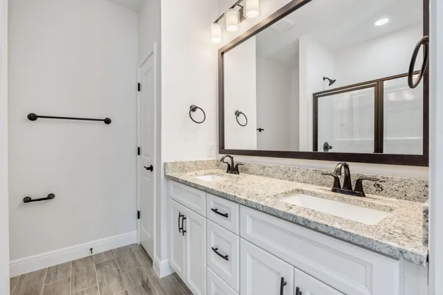 a bathroom with a glass shower door