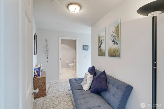 a living room with furniture and a view of bathroom