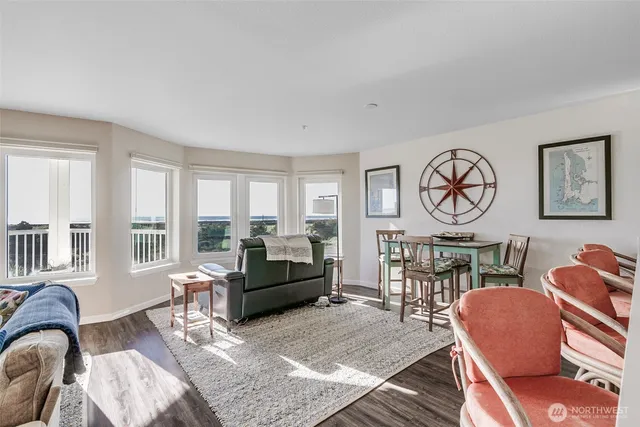 a living room with furniture a rug a window and a table