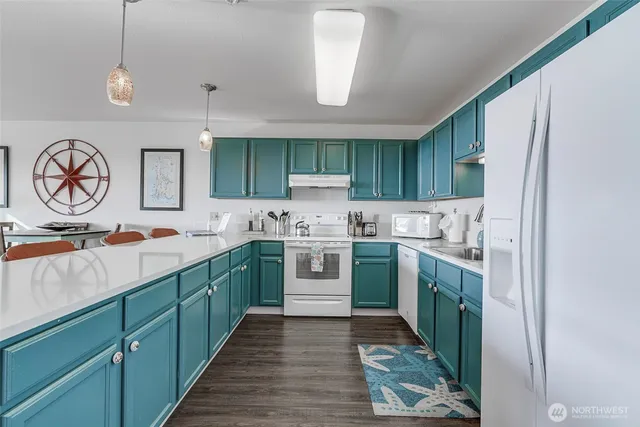 a kitchen with a sink cabinets and stainless steel appliances
