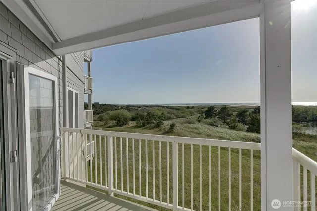 a view of a balcony with wooden floor