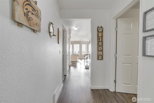 a view of hallway with wooden floor