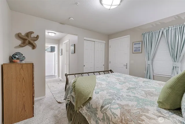 a bed room with a bed and a painting