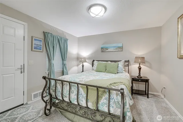 a bedroom with a bed and a mirror