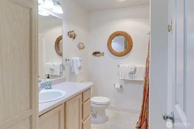 a bathroom with a toilet a sink and a mirror