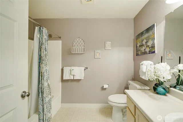 a bathroom with a sink mirror vanity and toilet