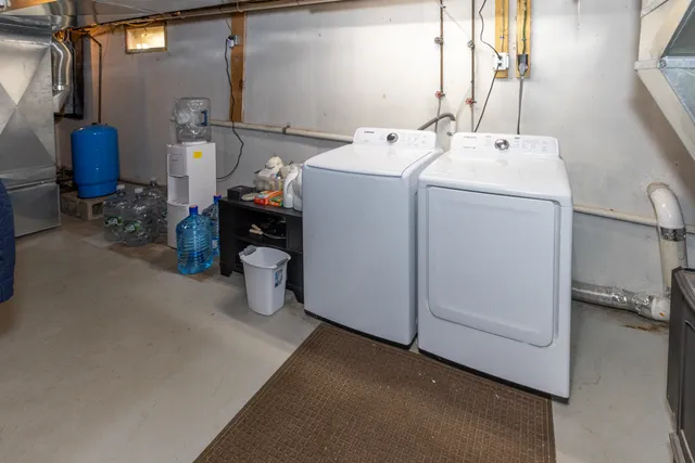 a view of storage and utility room with washer and dryer