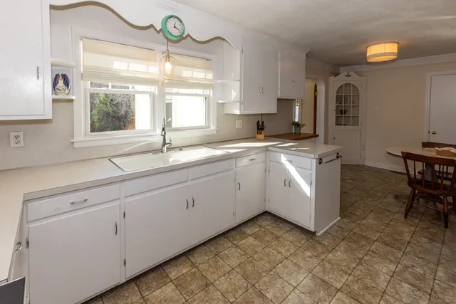 a kitchen with a sink cabinets and window