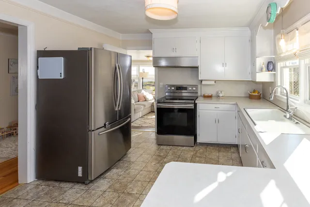 a kitchen with a refrigerator sink and stove