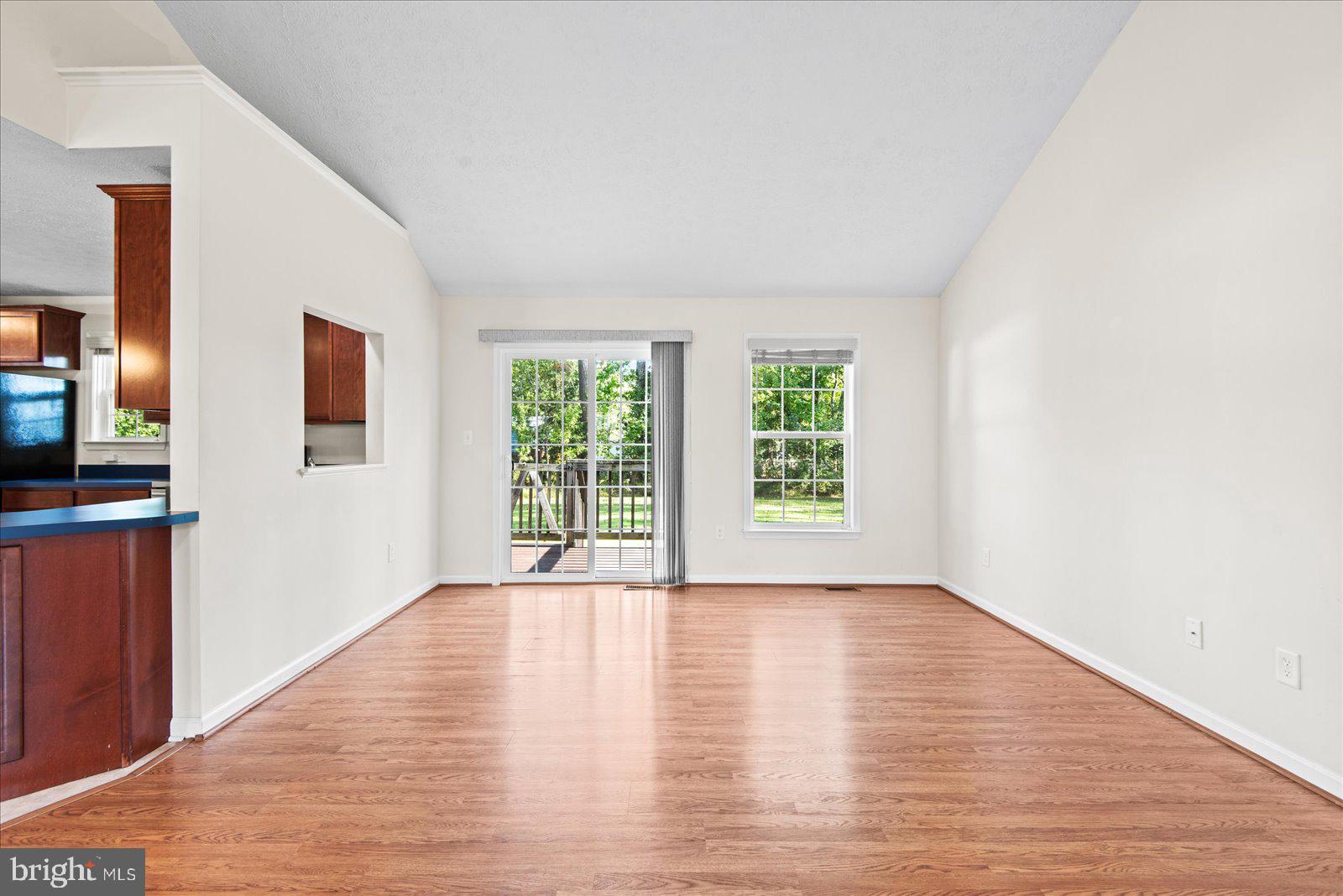 310 3rd Street Colonial Beach, VA 22443 - Photo 11 of 38 a view of an empty room with wooden floor and a window