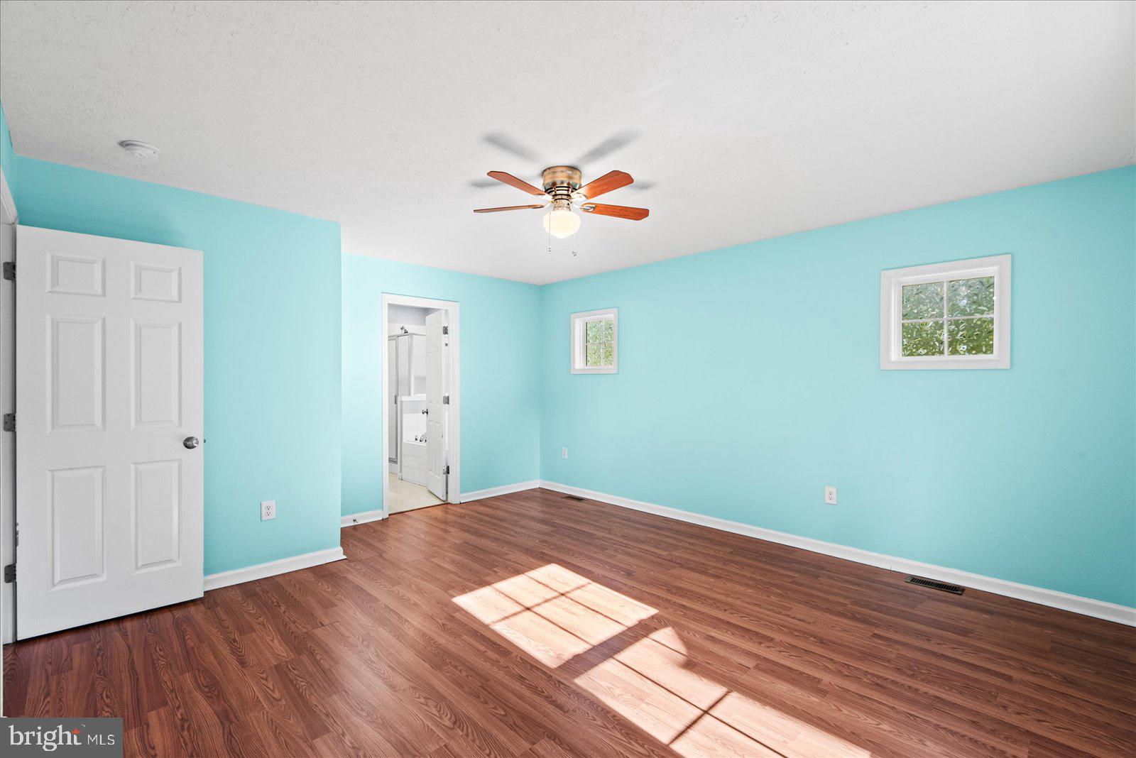310 3rd Street Colonial Beach, VA 22443 - Photo 20 of 38 a view of a big room with wooden floor and a chandelier fan