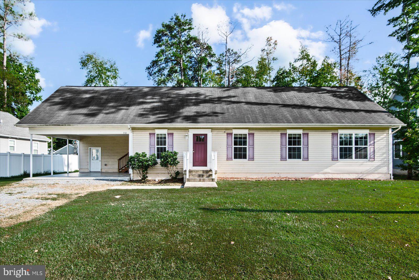 310 3rd Street Colonial Beach, VA 22443 - Photo 2 of 38 a front view of house with yard and outdoor seating