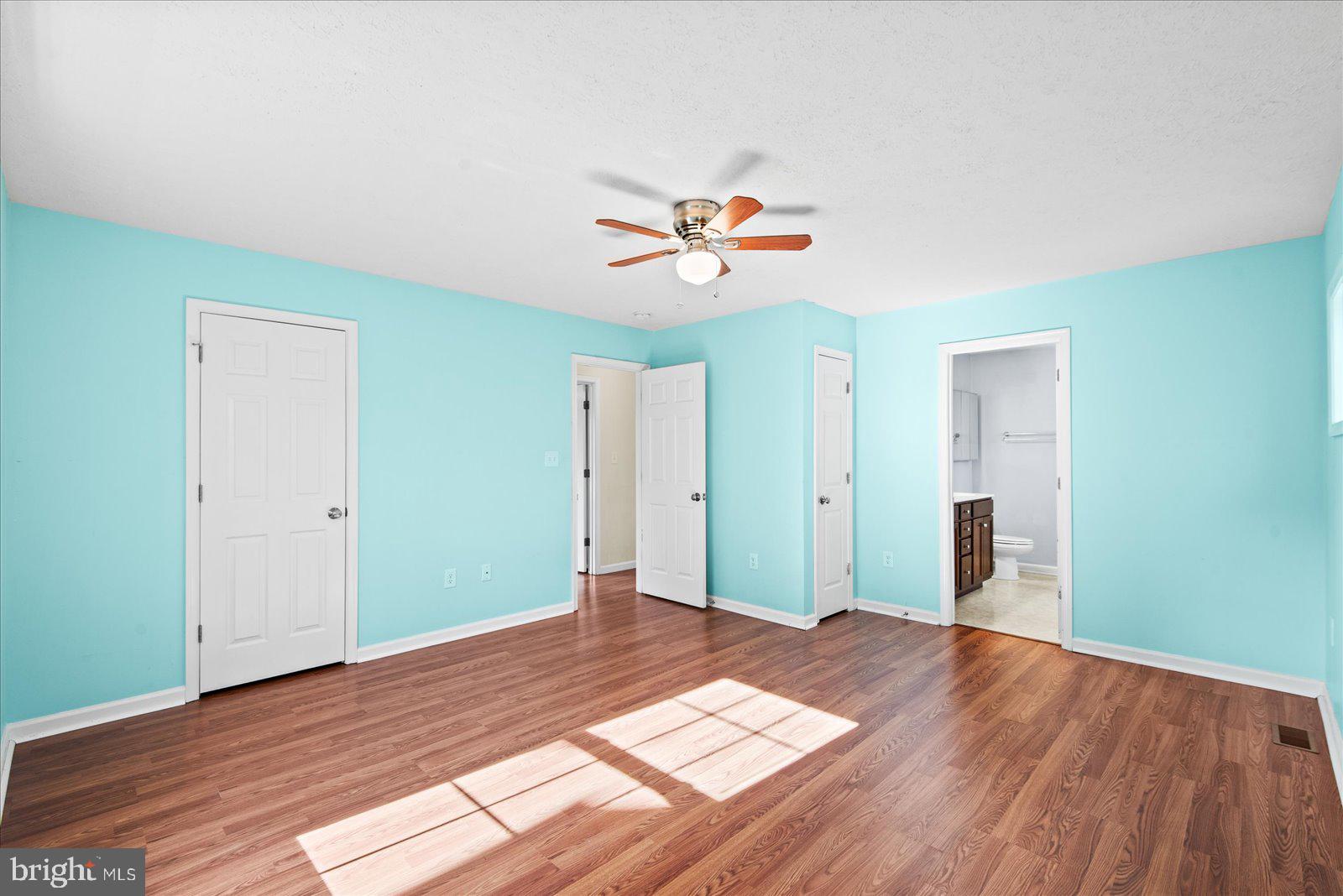 310 3rd Street Colonial Beach, VA 22443 - Photo 21 of 38 a view of a room with wooden floor and a ceiling fan