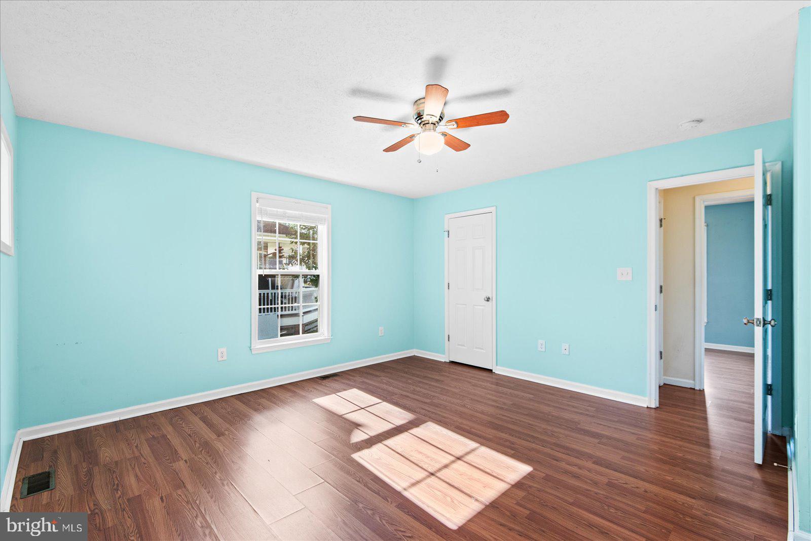 310 3rd Street Colonial Beach, VA 22443 - Photo 22 of 38 an empty room with wooden floor closet and windows