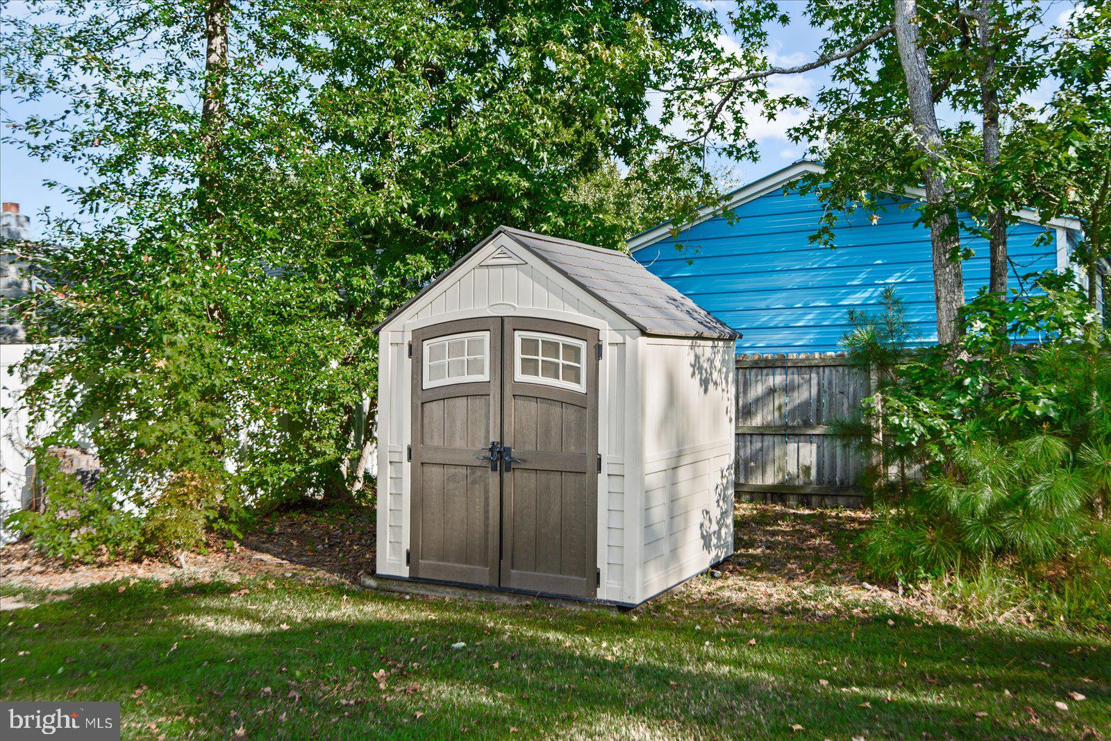 310 3rd Street Colonial Beach, VA 22443 - Photo 38 of 38 a view of a tiny house with a small yard plants and large tree