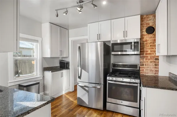 a kitchen with a refrigerator stove and microwave