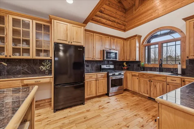 a kitchen with stainless steel appliances granite countertop a stove and a sink
