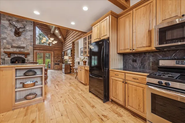 a view of a dining room with furniture a chandelier and wooden floor