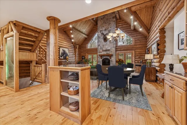 a living room with furniture a chandelier and a dining table