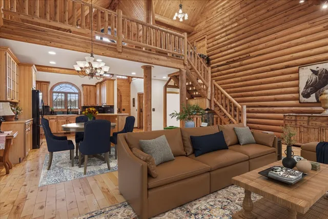 a spacious bedroom with a bed and a flat tv screen on dresser