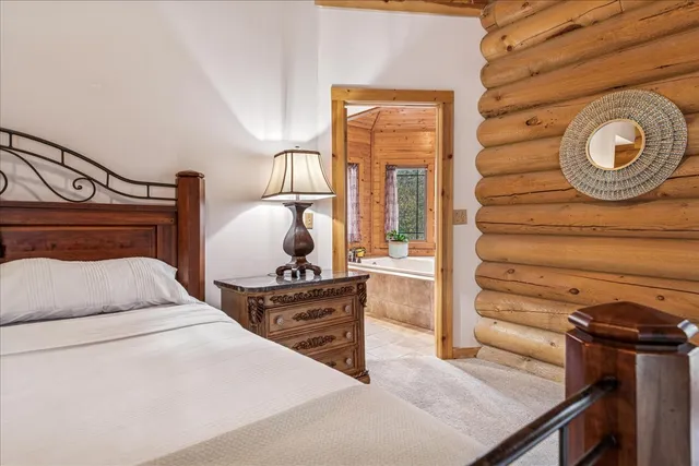 a large bathroom with a granite countertop sink a toilet a glass door shower and a mirror