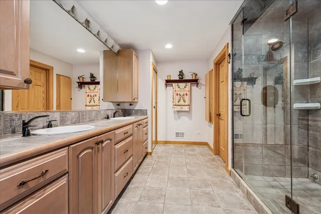 a large bathroom with a granite countertop sink mirror and a bath tub