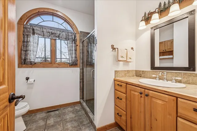 a view of a balcony with wooden floor and iron stairs