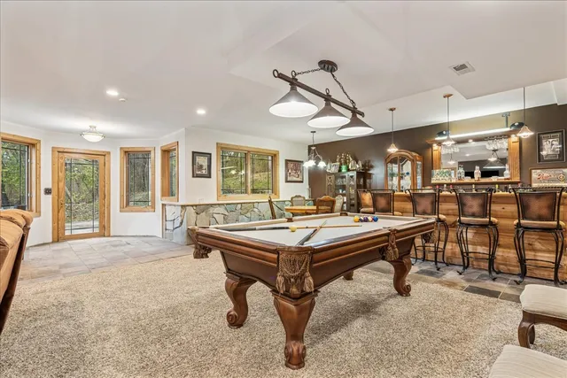 a room with lots of chairs and mirrors