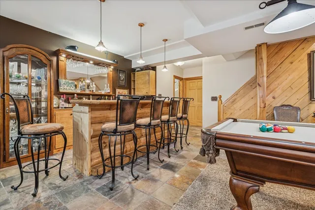 a bedroom with a bed and closet with mirror