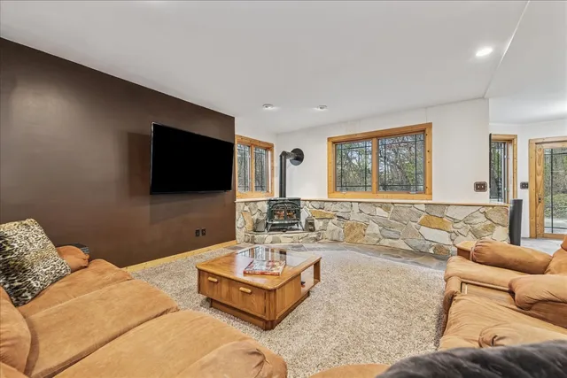 a bathroom with a granite countertop sink a mirror and a shower