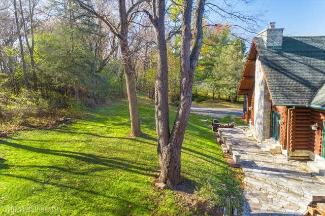 an aerial view of a house with a yard