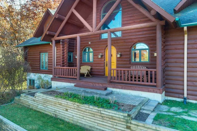 a view of a house with a yard and wooden fence