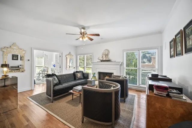 a living room with furniture fireplace and a large window