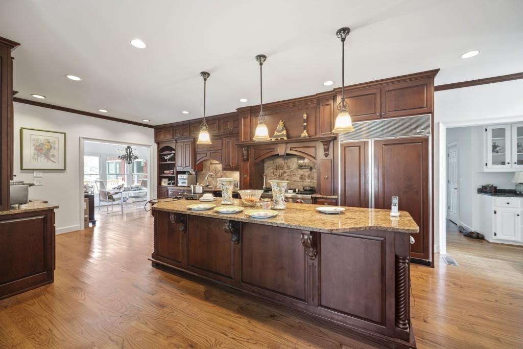 988 Grantham Way Southwest Marietta, GA 30064 - Photo 13 of 51 a view of a kitchen with kitchen island a sink wooden floor and living room view