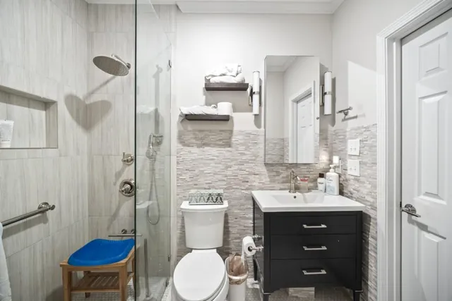a bathroom with a sink toilet and shower