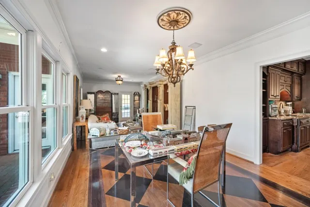 a view of a dining room with furniture wooden floor and chandelier