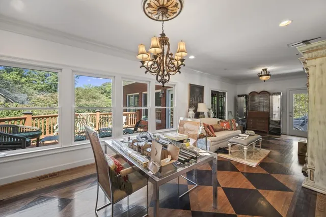 a view of a dining room with furniture wooden floor and chandelier