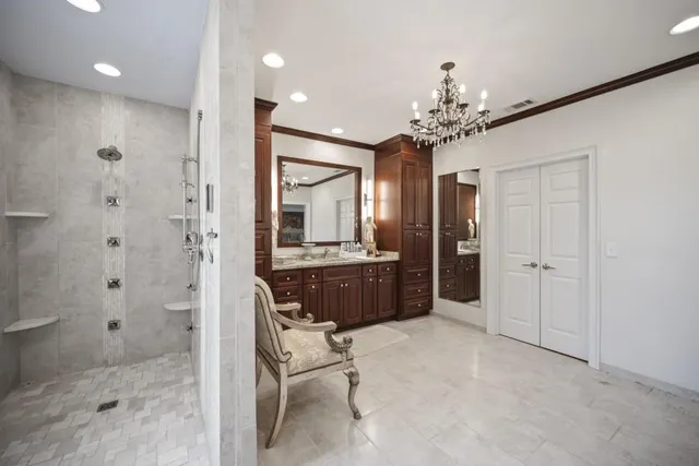 a bathroom with a shower a sink and a mirror