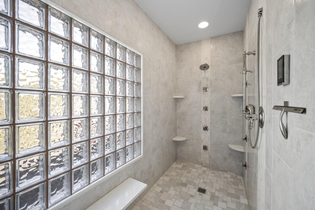 988 Grantham Way Southwest Marietta, GA 30064 - Photo 28 of 51 a bathroom with a granite countertop sink a mirror and a shower