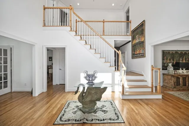 a view of entryway and hall with wooden floor