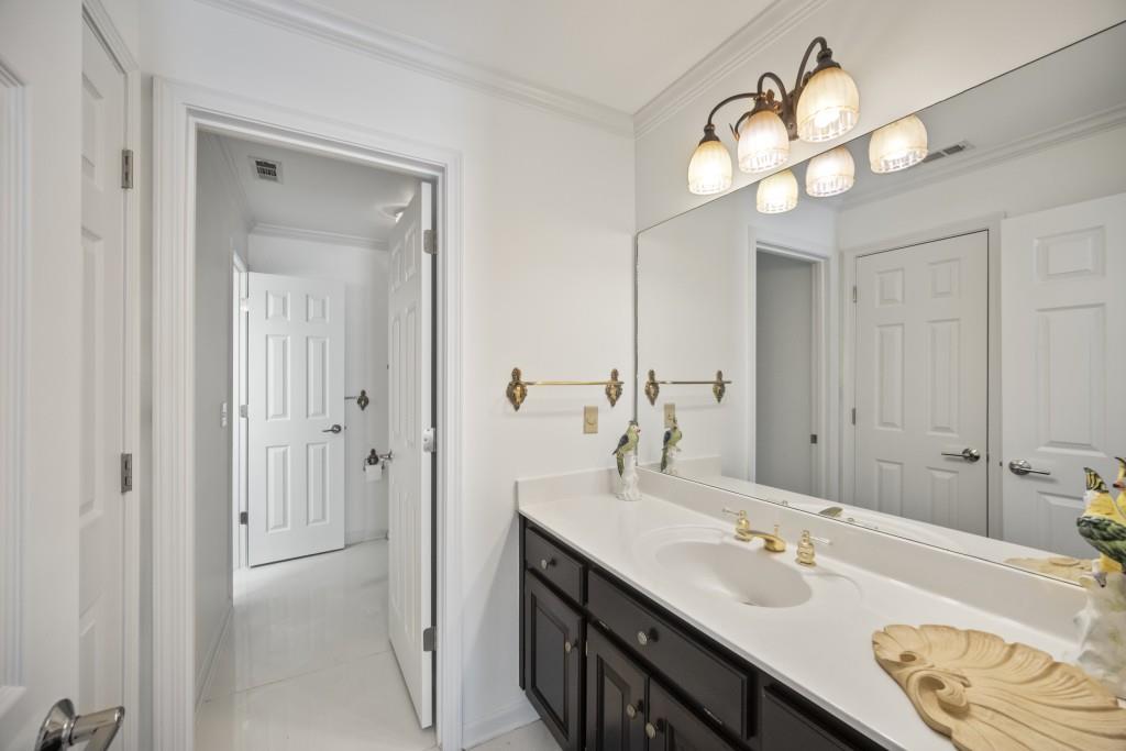 988 Grantham Way Southwest Marietta, GA 30064 - Photo 37 of 51 a bathroom with a double vanity sink and a mirror