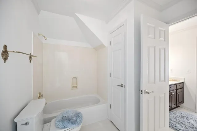 a bathroom with a bathtub a toilet and a shower